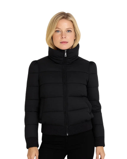 Woman wearing a black puffer jacket on a white background
