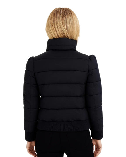 Black puffer jacket worn by a person on a white background