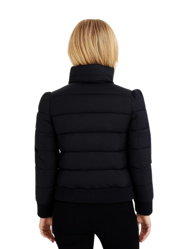 Black puffer jacket worn by a person on a white background