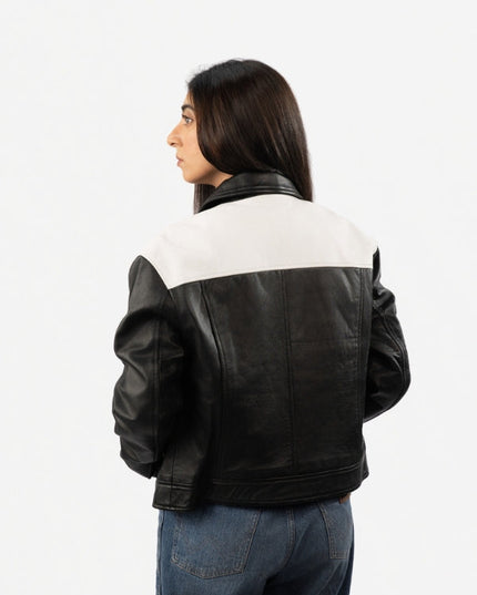 Person wearing a black and white jacket on a white background