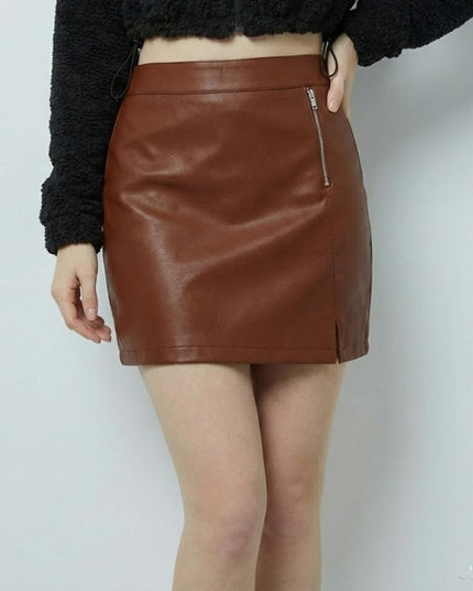 Brown leather skirt worn by a person on a white background