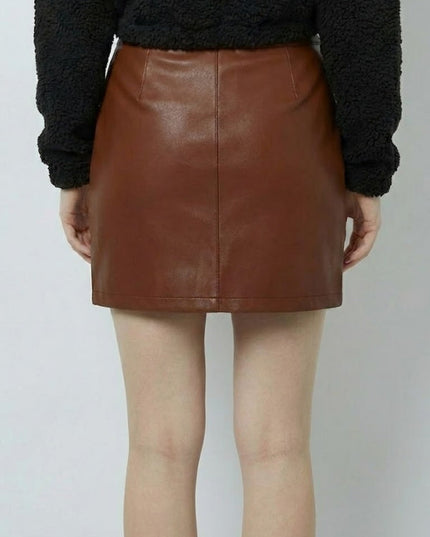 Brown leather skirt worn by a person on a plain background