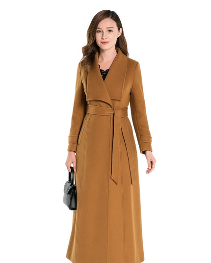 Woman wearing a long brown coat on a white background