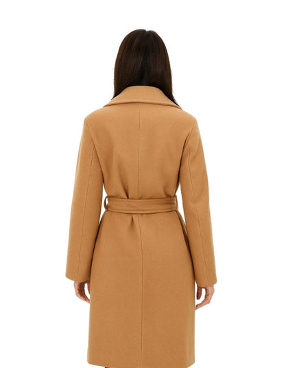 Woman wearing a tan coat on a white background