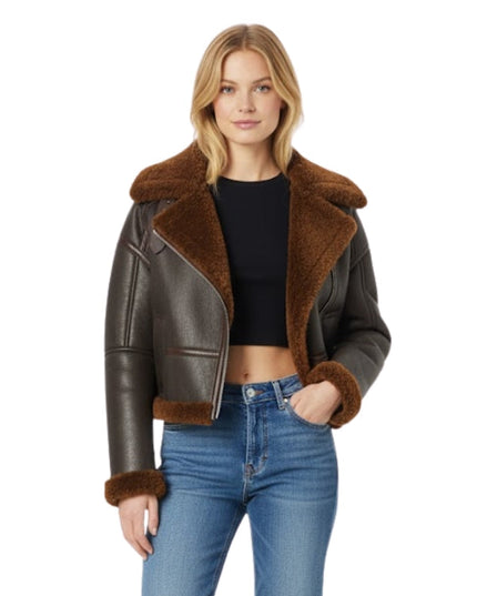 Woman wearing a brown leather jacket with fur trim on a white background