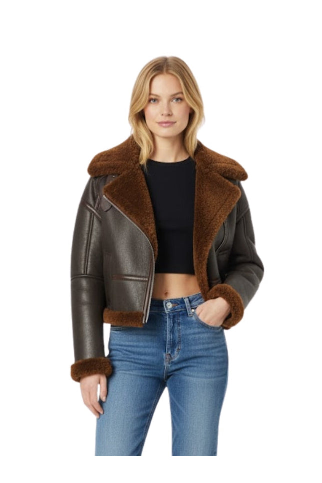 Woman wearing a brown leather jacket with fur trim on a white background