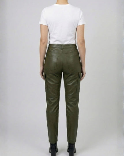Person wearing green leather pants on a plain background