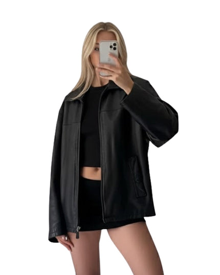 Person wearing a black leather jacket and black outfit on a white background