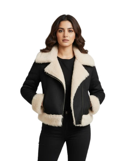 Woman wearing a black and beige shearling jacket on a white background