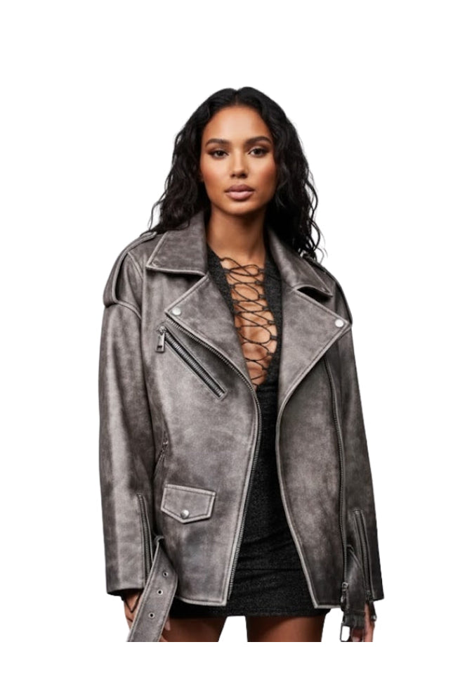 Woman wearing a gray suede jacket on a white background