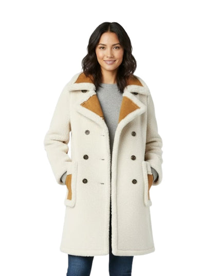 Woman wearing a cream-colored coat with brown accents on a white background
