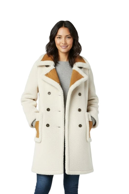 Woman wearing a cream-colored coat with brown accents on a white background