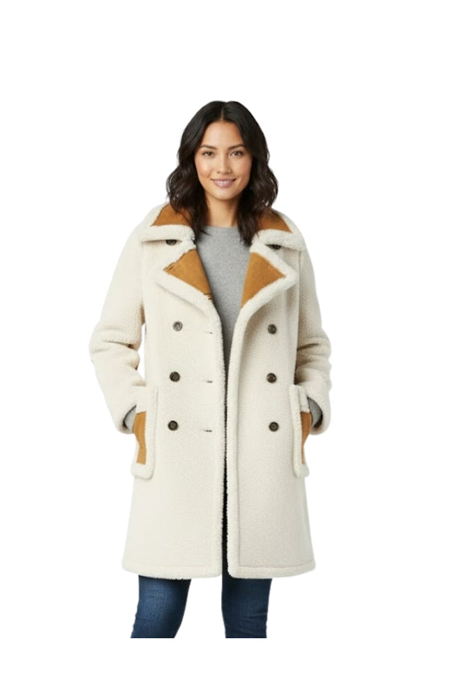 Woman wearing a cream-colored coat with brown accents on a white background