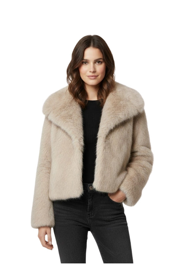 Woman wearing a beige fur jacket on a white background