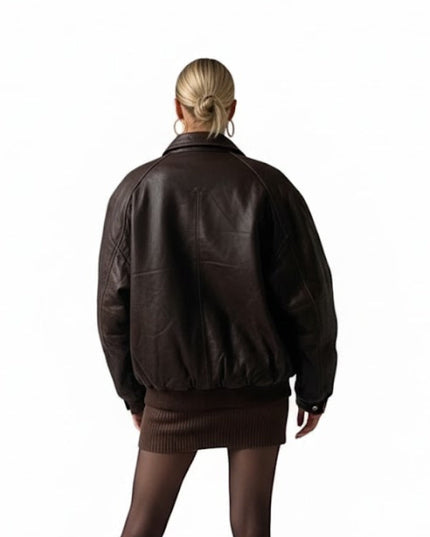 Person wearing a brown leather jacket and skirt on a white background