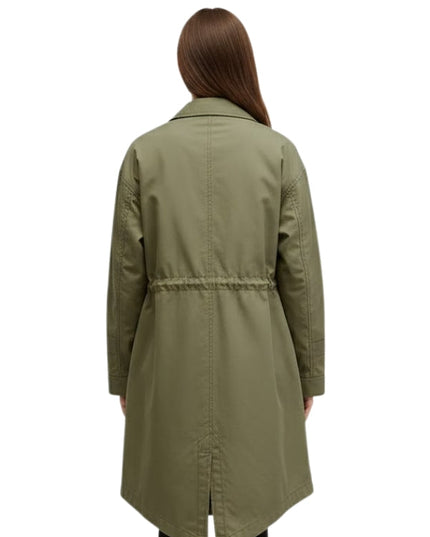 Person wearing a green trench coat on a white background