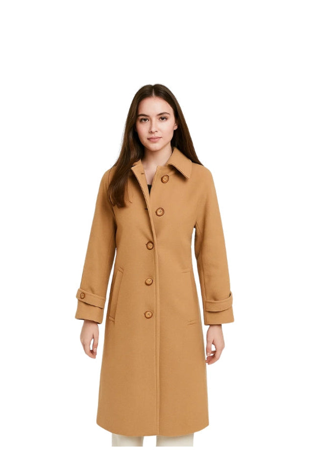 Woman wearing a tan coat on a white background