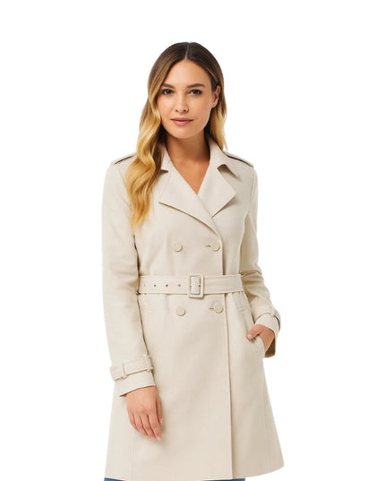 Woman wearing a beige trench coat on a white background
