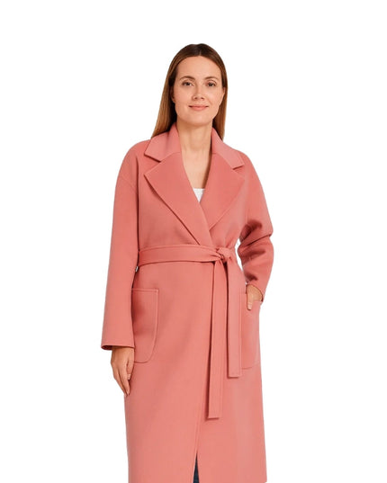 Woman wearing a pink coat on a white background