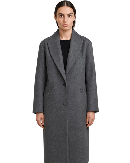 Woman wearing a gray coat on a white background