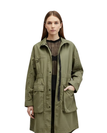 Woman wearing a green jacket on a white background