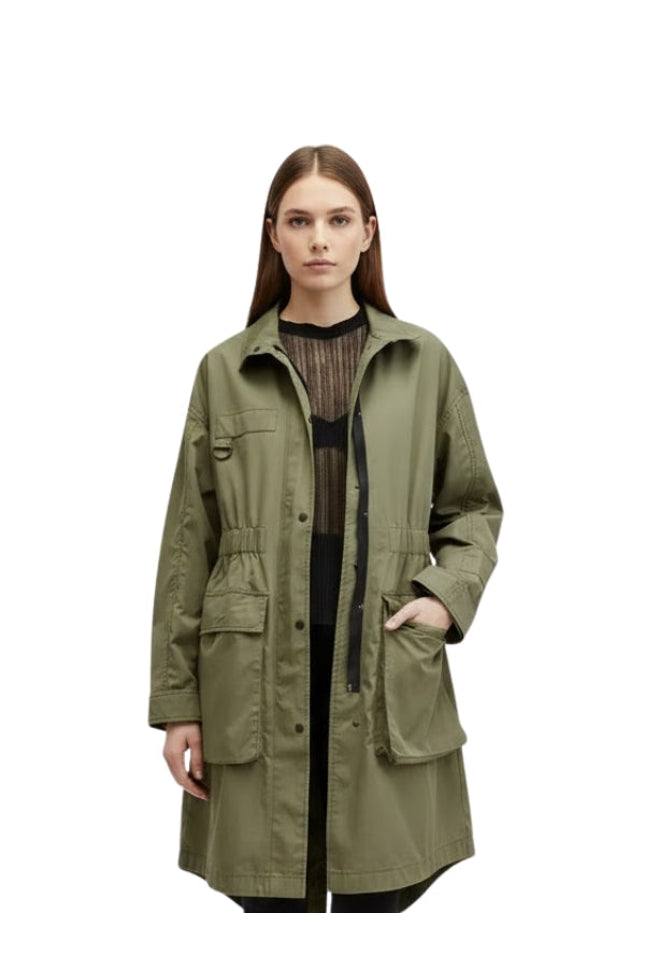 Woman wearing a green jacket on a white background