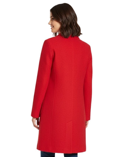 Woman wearing a red coat on a white background
