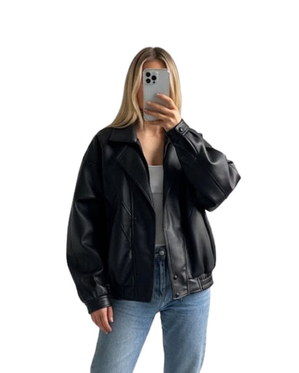 Person wearing a black leather jacket and blue jeans on a white background