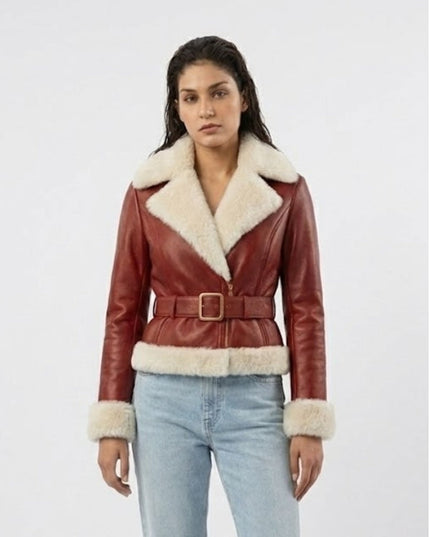 Woman wearing a red leather jacket with white fur trim on a white background