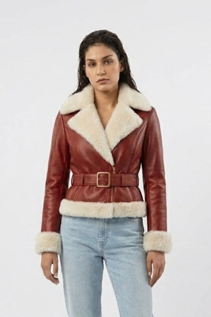 Woman wearing a red leather jacket with white fur trim on a white background