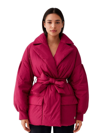 Woman wearing a pink jacket on a white background