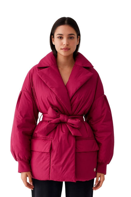 Woman wearing a pink jacket on a white background