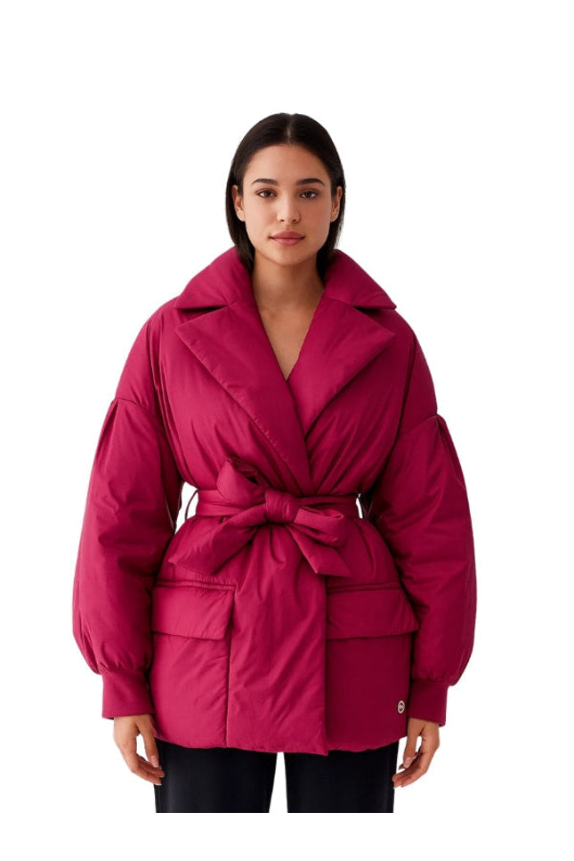 Woman wearing a pink jacket on a white background