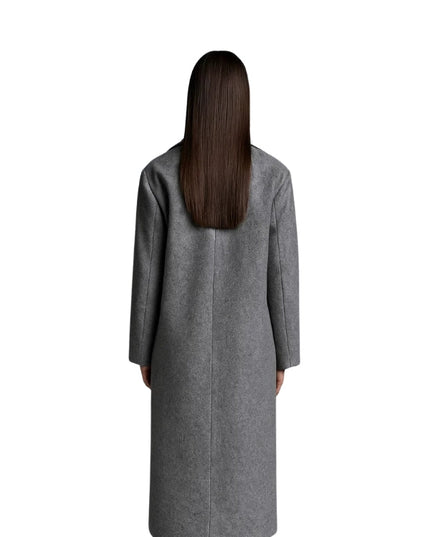 Person wearing a gray coat from behind on a white background