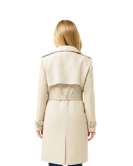 Woman wearing a beige trench coat on a white background