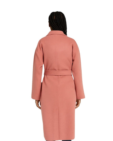 Person wearing a pink coat on a white background