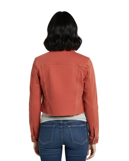 Person wearing a rust-colored jacket and blue jeans on a white background