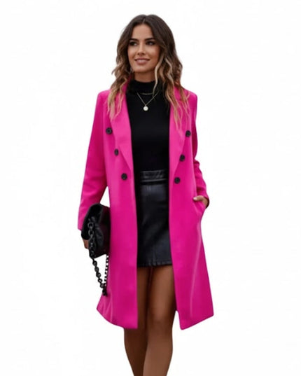 Woman wearing a bright pink coat on a white background