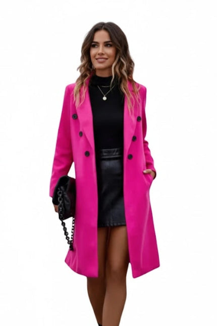 Woman wearing a bright pink coat on a white background