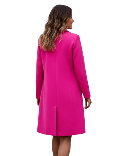 Woman wearing a bright pink coat on a white background