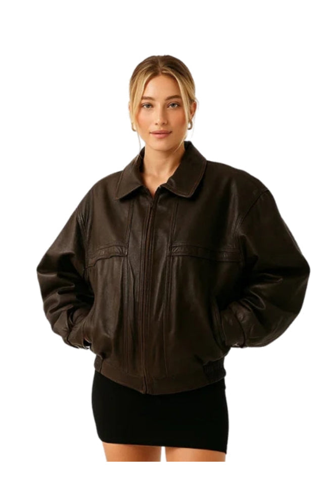Woman wearing a brown leather jacket on a white background