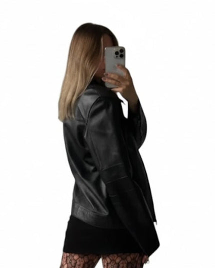 Person wearing a black leather jacket taking a mirror selfie on a white background