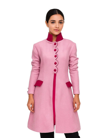 Pink coat with red accents worn by a model on a white background