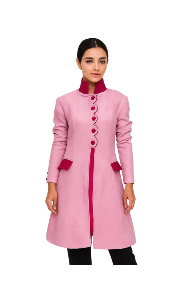 Pink coat with red accents worn by a model on a white background