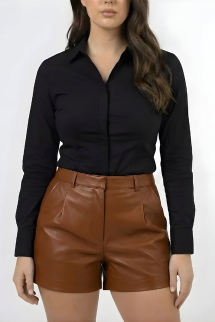 Person wearing a black shirt and brown leather shorts on a white background