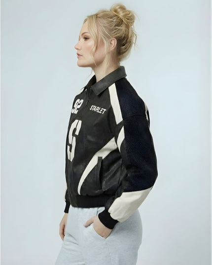 Woman wearing a black and white jacket with visible branding on a light gray background