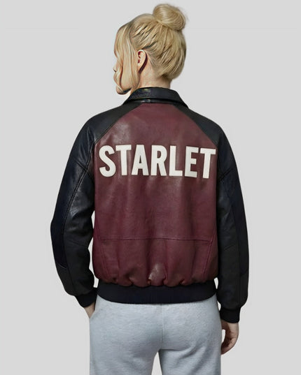 Person wearing a maroon and black jacket with 'STARLET' on the back against a plain background