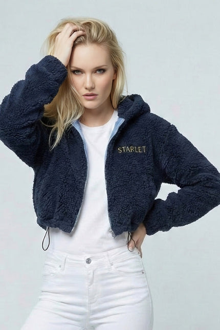Woman wearing a navy blue fleece jacket with 'STARLET' branding on a light gray background