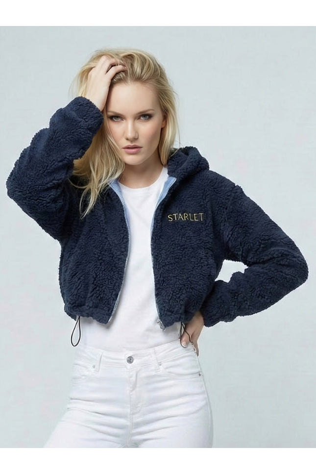 Woman wearing a navy blue fleece jacket with 'STARLET' branding on a light gray background