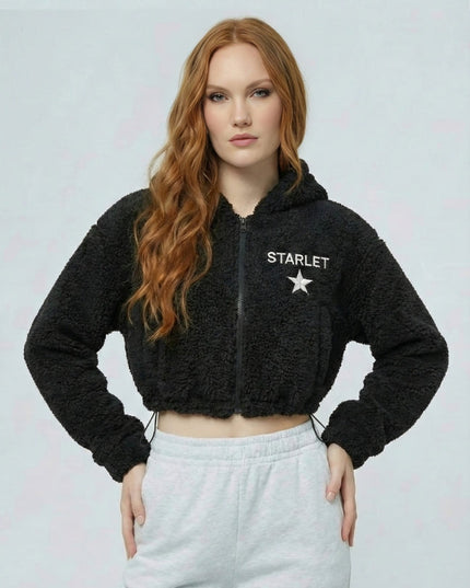 Woman wearing a black 'STARLET' hoodie with a white star logo on a light gray background